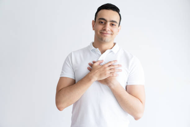 istock Thankful young man keeping hands on chest 975705452