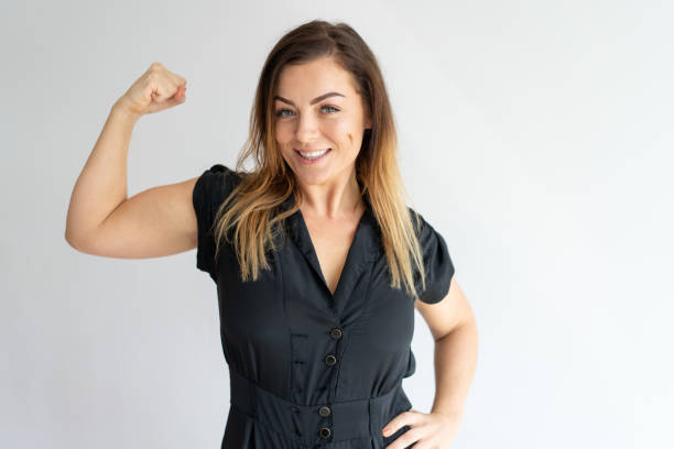 istock Positive joyful lady showing hand muscles 975708182