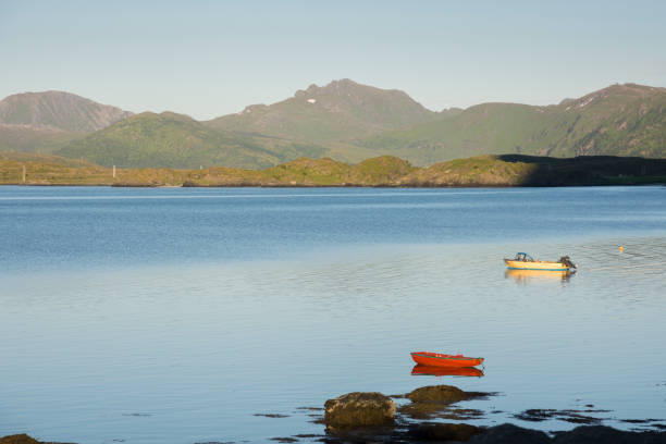 istock boat at midnight sun in Eggum in Norway 975716102