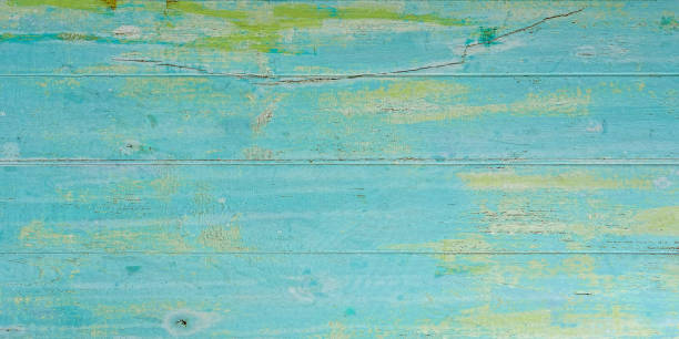 istock Old blue, green and turquoise colored grungy wood panel board background. 975718716