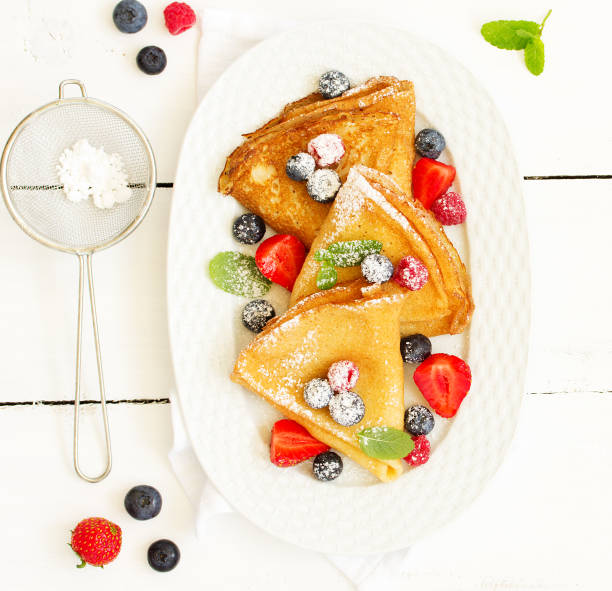 istock Pancakes with fresh berries and honey. 975719176