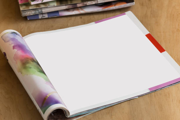 istock Blank glossy magazine on wooden background. 975730630