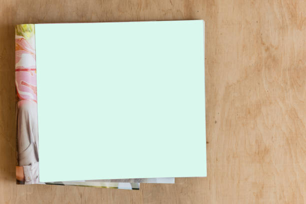 istock Blank glossy magazine on wooden background. 975730672
