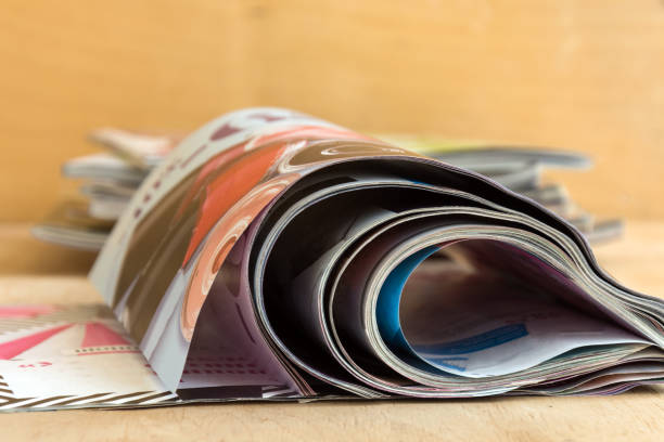istock Creative glossy magazines on wooden background. 975730698