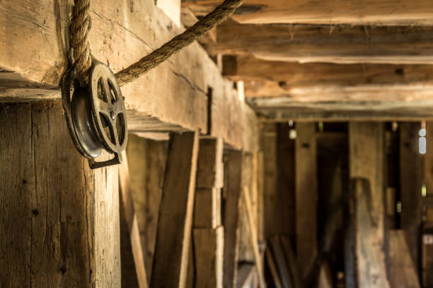 istock Vintage pulley and rope in old barn 975732066