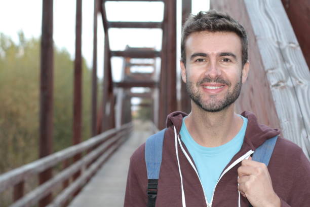 istock Scruffy outdoorsy man smiling close up 975735022