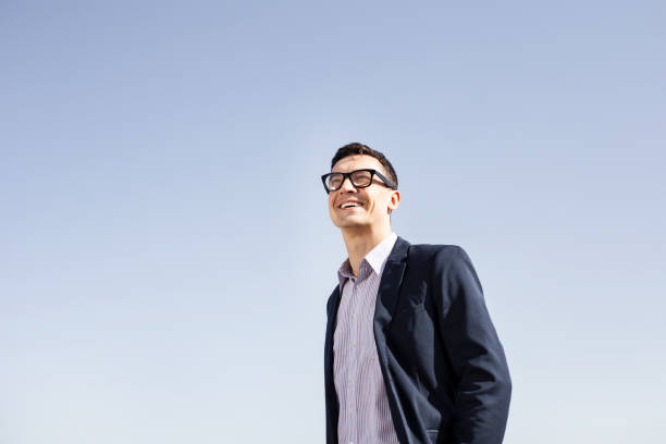 istock Beaming elegant businessman looking into the sky 975735850