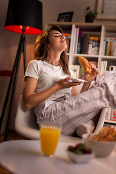 istock Woman eating a croissant 975737476