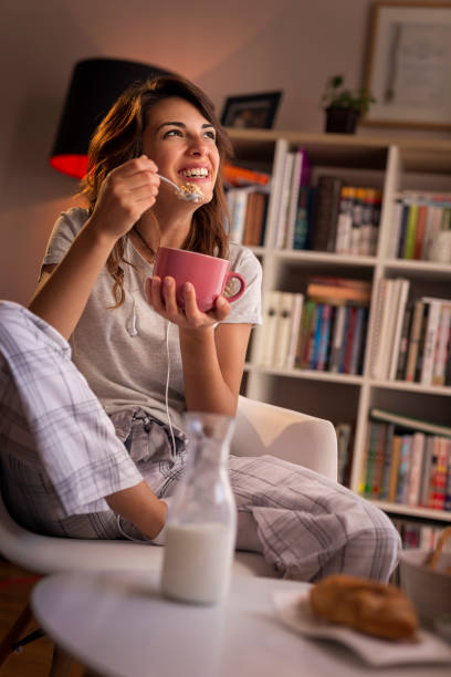 istock Woman eating breakfast cereal 975737684