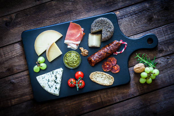 istock Cheese and cold meat board shot from above on wooden table 975738498