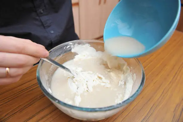 Photo of Prepare the dough for pizza, hand knead the dough with yeast