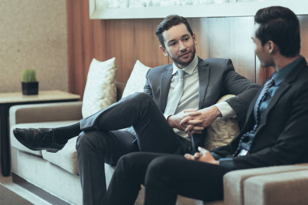 istock Two Content Business Men Chatting in Lounge 975744594