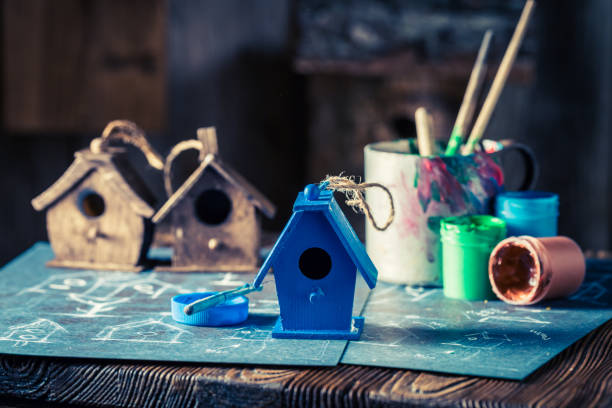 istock Small feeder for birds and blue plan to build it 975745220