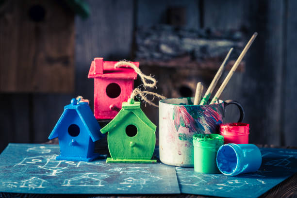 istock Homemade home for birds and blue construction scheme 975745312