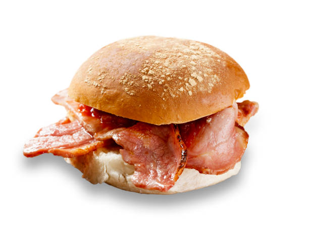 delicious bacon roll shot on white, and cut out with a drop shadow - bun imagens e fotografias de stock