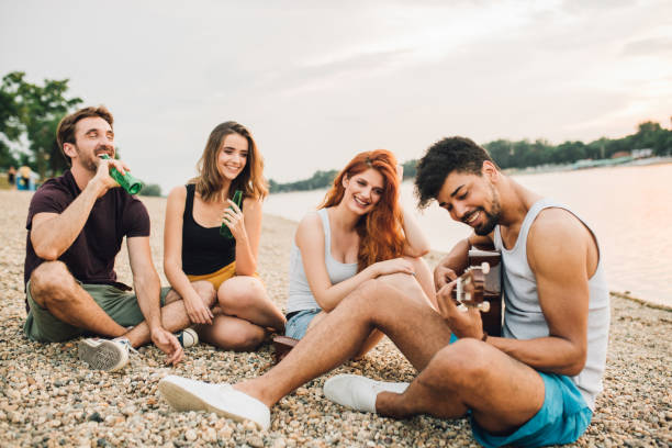 istock Young couples enjoying some music by the river 975755130