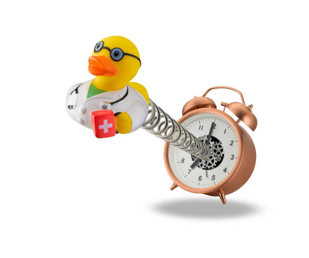 Doctor rubber duck springing out of alarm clock