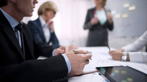 istock Man taking notes during his colleague presentation in office, teambuilding 975777320
