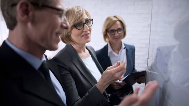 istock Happy business colleagues rejoicing studying dynamics of increasing profits 975777704