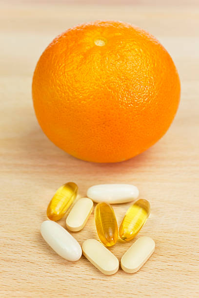 istock Orange and Nutrition Supplement Tablets or Medicine 97578366