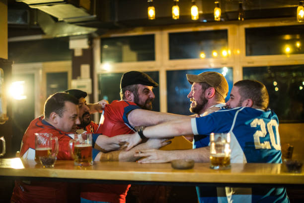 istock Soccer fans fighting in bar 975789762