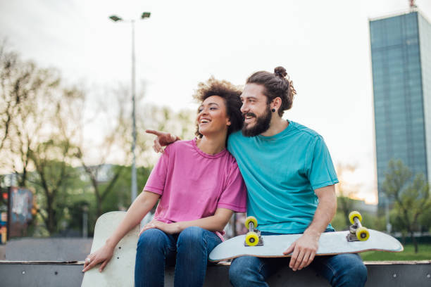 istock Happy couple with skate boards at the park 975790090
