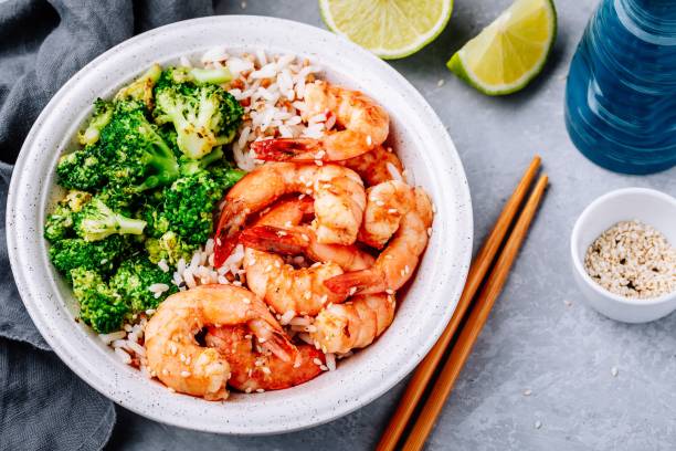 istock Spicy Shrimp Burrito Bowl with cilantro lime rice and broccoli 975790738