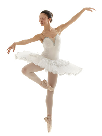 Bailarina con tutú blanco haciendo el piqué posan sobre fondo blanco photo