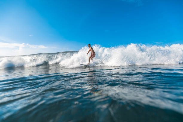 istock athletic young man riding on waves on sunny day 975798080