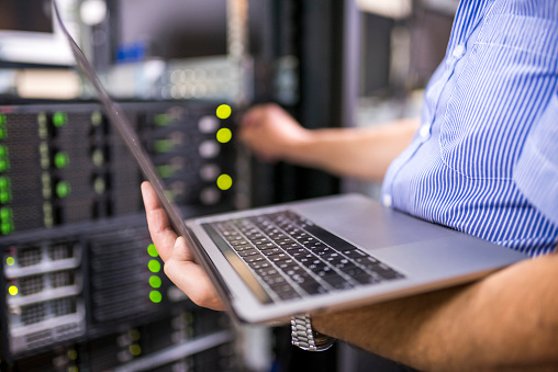 Engineer in the server room close-up. Photo taken at a Data Center in Bulgaria, Eastern Europe.