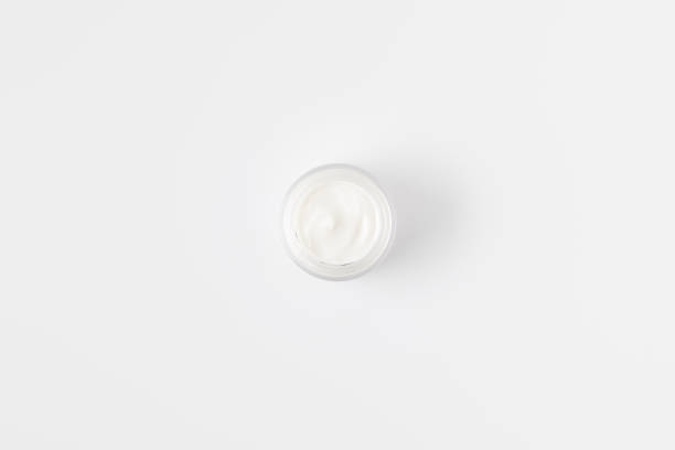 istock elevated view of organic cream in container isolated on white background 975811094