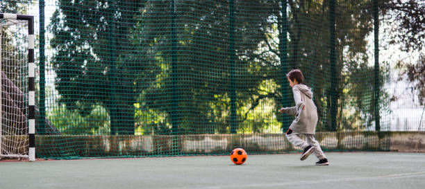 istock Boy play with football ball 975814916