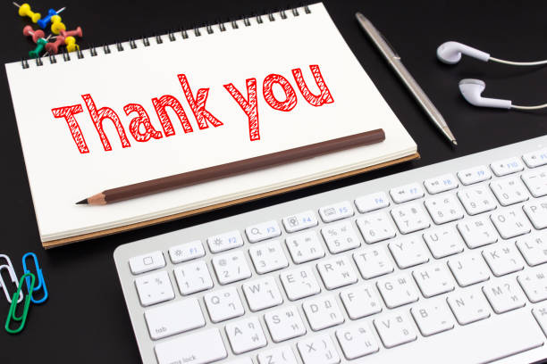 istock Word text Thank you on white paper on office table / business concept 975821502