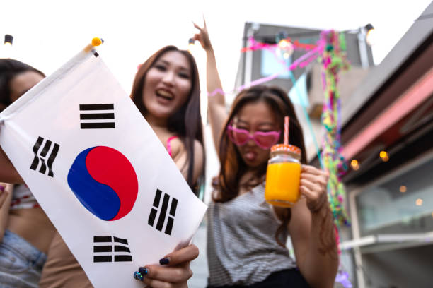 Friends party and fun on a rooftop terrace in Seoul Friends party and fun on a rooftop terrace in Seoul - South Korea. south korea south korean flag korea flag stock pictures, royalty-free photos & images