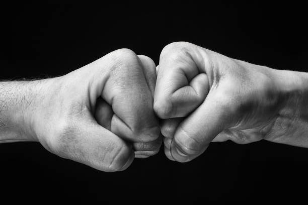 istock black and white clash of two fists 975822402
