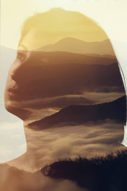 istock Woman's portrait on mountain landscape background. 975823224