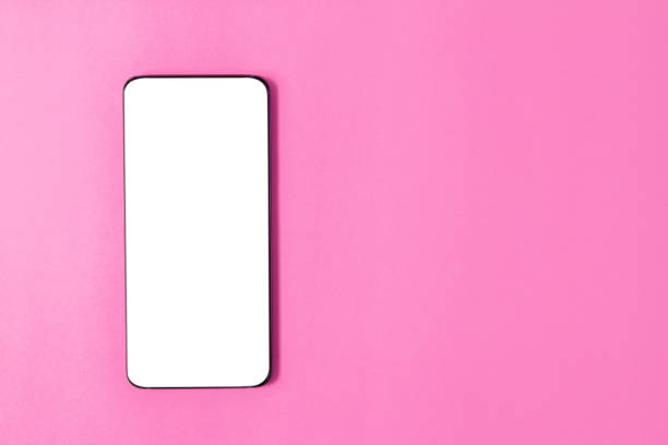 istock Top view, smart phones on a pink background. Modern technology, mobile communication. Layout on the left. 975828354