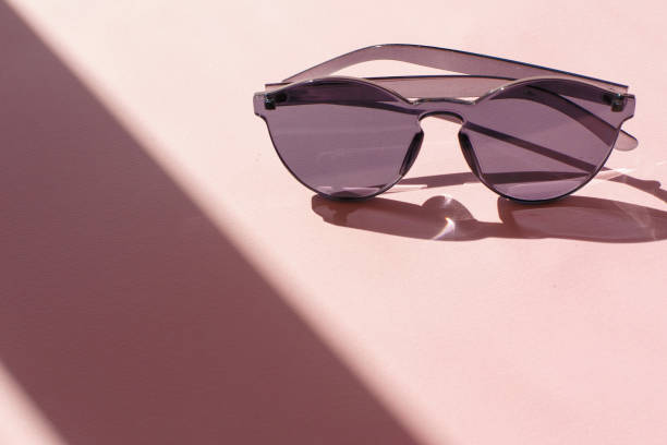 istock black sunglasses on trendy pink paper background in sun light. flat lay. creative contrast summer image. vacation and party concept. space for text. tropical summer holidays 975831494