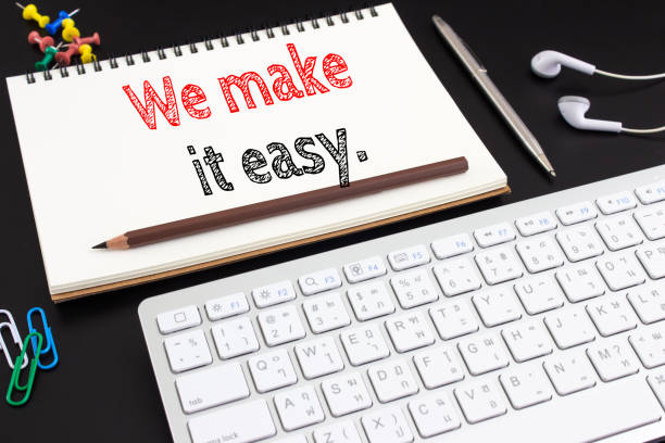 istock Word text We make it easy on white paper on office table / business concept 975833648