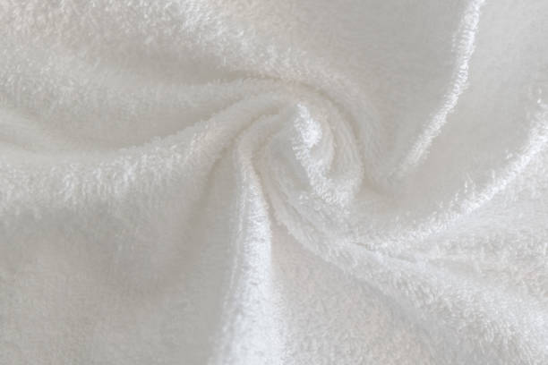 istock Close up view on white cotton towel. Spa and wellness thing. Selective focus 975843156