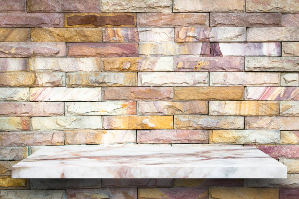 istock Empty top marble shelves and stone wall background / for product display montage product display 975858938