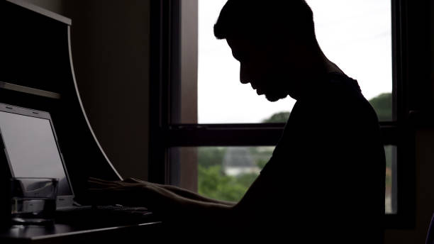 istock Man imagines playing piano, typing on computer keyboard, male writer silhouette 975859626