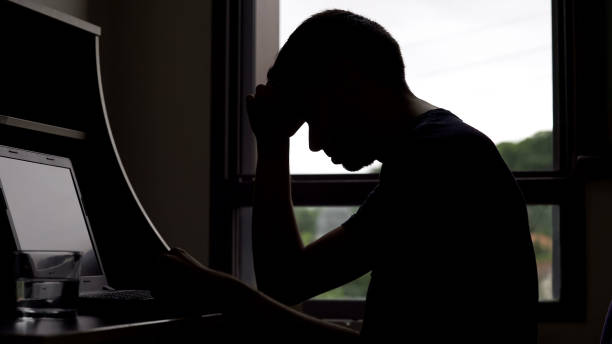 istock Lonely sad man looking for job online, unemployment and depression, problems 975859634