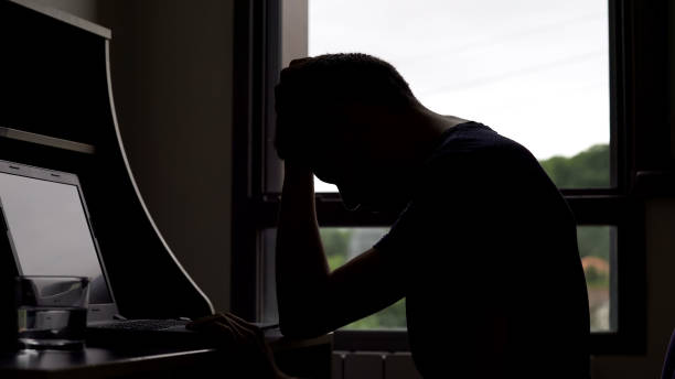 istock Depressed man reading bad news on laptop, male having financial problems 975859638