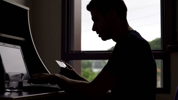 istock Man inserting credit card number on laptop, online shopping, modern technologies 975859642