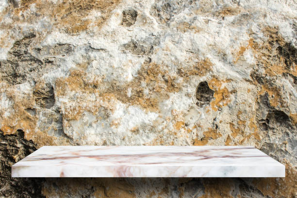 istock Empty top marble shelves and stone wall background / for product display montage product display 975860480