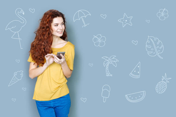 istock Beautiful student holding a phone and planning her journey 975865974