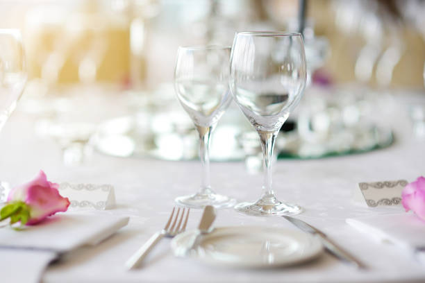 istock Beautiful table setting with crockery and flowers for a party, wedding reception or other festive event 975873822
