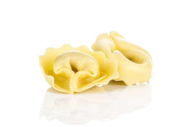 istock Fresh Raw Tortelloni stuffed pasta isolated on white 975878840
