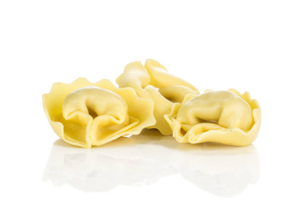 istock Fresh Raw Tortelloni stuffed pasta isolated on white 975878882